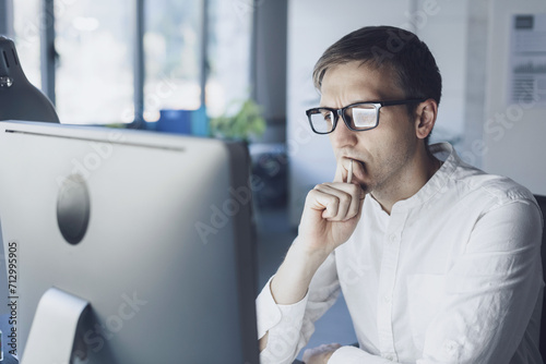 Businessman working with his computer and thinking