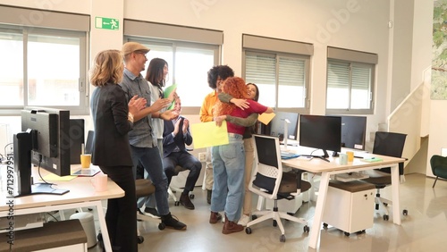 Joyful office team celebrates with hugs and cheers