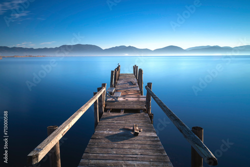 Wooden pier at sunrise. Lake Massaciuccoli, Tuscany, Italy