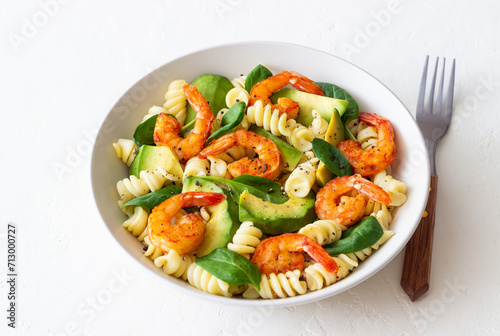 Pasta salad with shrimps, avocado and spinach. Healthy eating. Seafood.