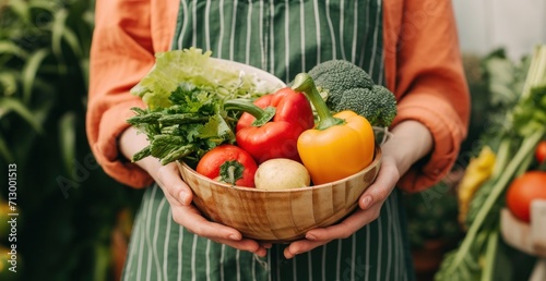 woman holding bowl of vegetables in hand © olegganko