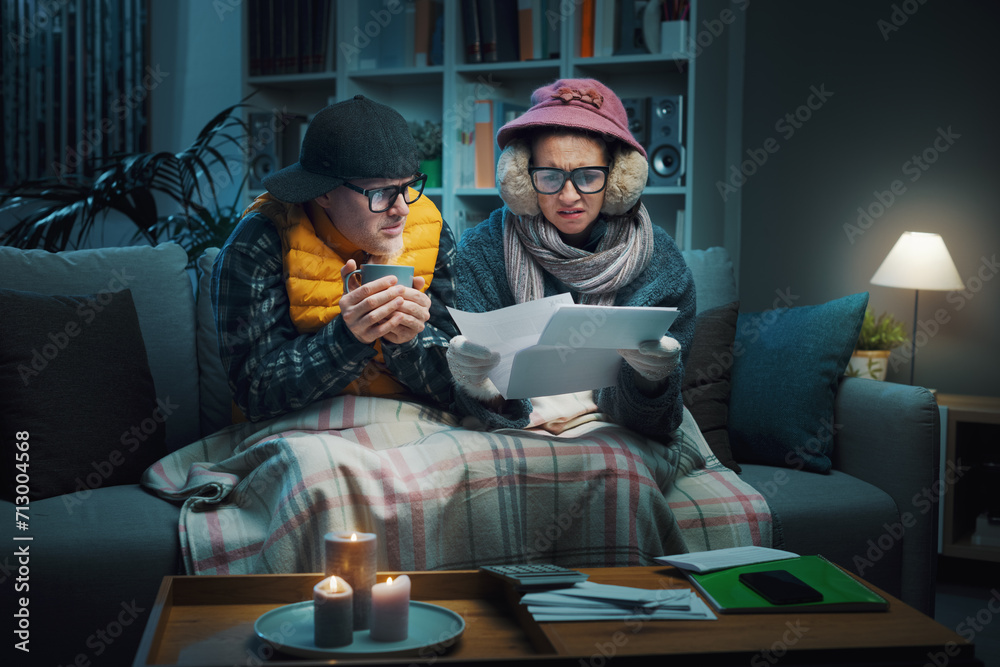 Sad couple checking expensive utility bills