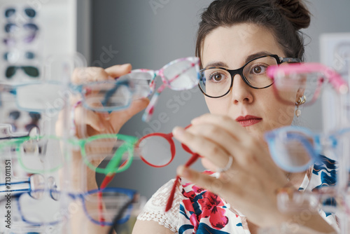 Young woman choosing her new glasses