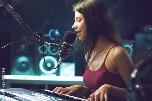 Young female artist working in the recording studio photo