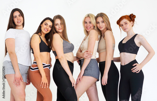 Happy different race women wearing sports top and leggings