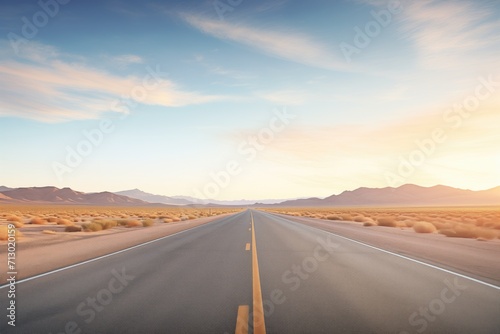 desert highway vanishing into the horizon at sunrise photo