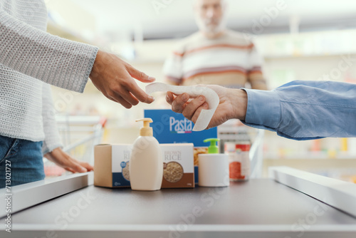 Customer receiving the grocery receipt at the supermarket photo
