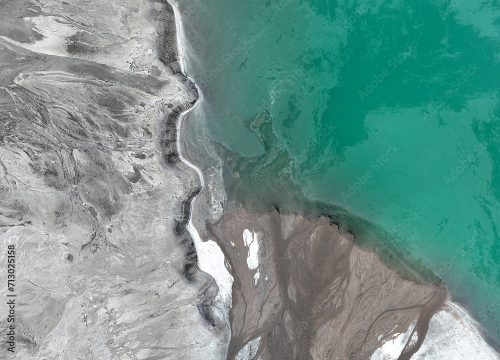 Naklejka premium aerial view of green or turquoise polluted water with dirt flowing into a lake from a thermal plant or chemical industry factory