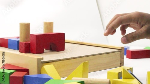 A child play Colorful wooden puzzle toys being assembled