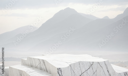 marble stone rock, white podium for product placement against mountain background. Stone platform in front of mountain panorama.