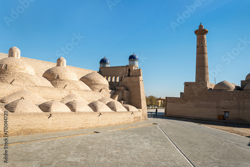 Architectural complex Palvan-darvaza of eastern gate of the Ichan-Kala fortress. Domes of Anush-Khan Bathhouse, trade gallery and minaret of Sayid Niaz Sheliker Madrasah. Khiva, Uzbekistan