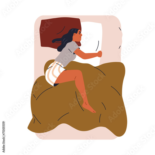 Woman asleep. Female sleeping alone on double bed, hugging pillow with arms, ...