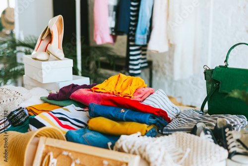 swap party for try on clothes, bags, shoes and accessories, garage sale, second hand and zero waste life, eco-friendly approach to consumption, clothes hanger in loft interior