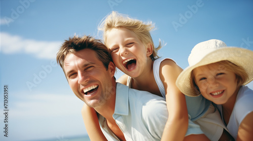 Portrait of happy family having fun on the beach against blue sky © wipawan