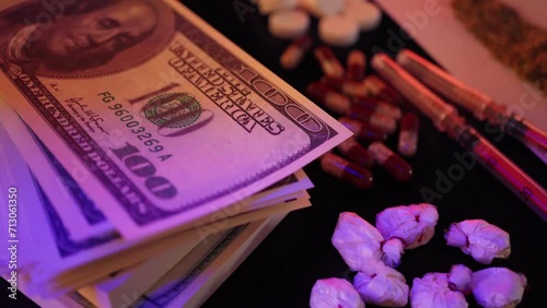 Close-up of drugs and money. Human addiction. Harm to health and violation of the law. photo
