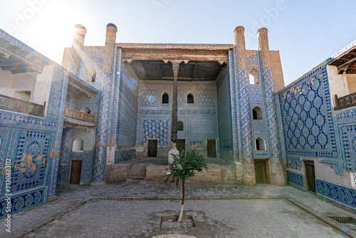 Khan palace with carved wooden column and walls with beautiful intricate ornament tiles in old city of Ichan-Kala photo