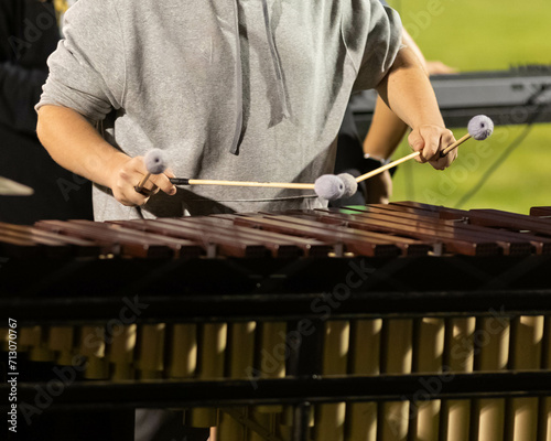 flashing mallets of the sideline percussionists at rehearsal