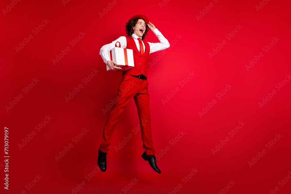 Full length body size photo of jumper mister guy wearing red costume touching hat bring wrapped surprise isolated on bright background Full length body size photo of jumper mister guy wearing red costume touching hat bring wrapped surprise isolated on bright background