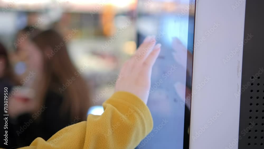 Woman choosing food via self-service machine at fast food restaurant. Girl using touch terminal im makes a quick order through the self-service. Person swipes the screen making an order.4K Woman choosing food via self-service machine at fast food restaurant. Girl using touch terminal im makes a quick order through the self-service. Person swipes the screen making an order.4K