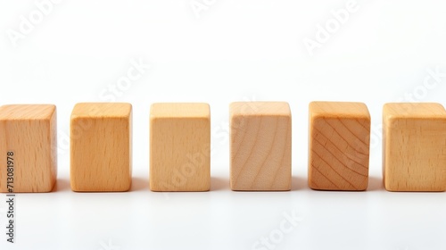 Row of small natural wooden blocks on white background for text placement and copy space photo