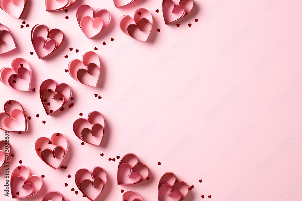 St Valentine Day background with paper elements in shape of heart and confetti on pink background. Minimal style. Top view.
