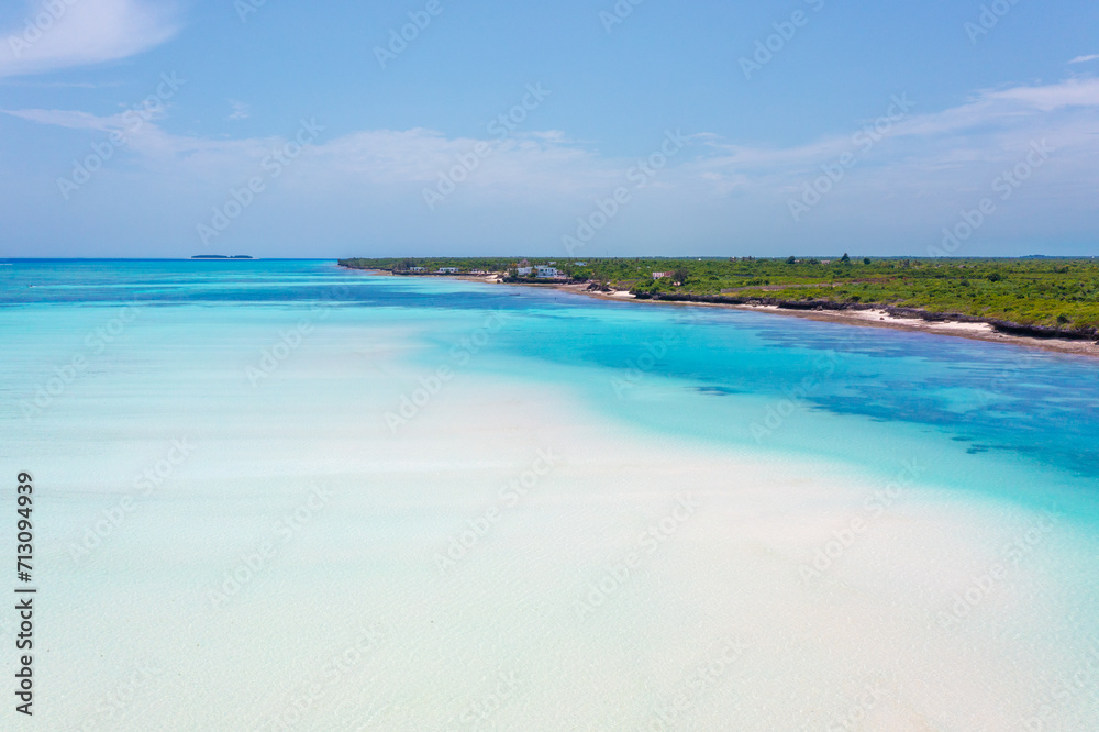 Pristine white tropical beach with blue sea, Zanzibar.