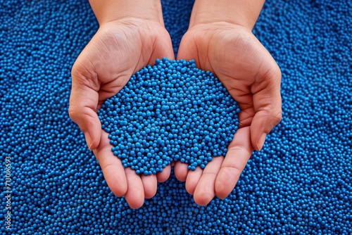 PVC granulate in hands, recycled plastic granules, biodegradable plastic. Granules of eco-friendly plastic raw material at the factory