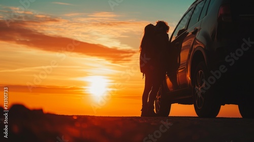 Silhouette kissing men and women at sunset stay near the car. A couple in love travels by car at sunset. photo