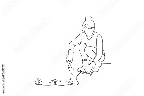 Wallpaper Mural Single continuous line drawing of Woman planting plants. Minimalism metaphor concept. Dynamic one line draw graphic design vector illustration.
 Torontodigital.ca