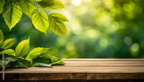 green leaves on wooden background.a wooden tabletop illuminated by bright sunlight  adorned with various leaves  and set against a naturally blurred green background  creating a harmonious and comfort