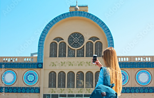 Canvas Print Woman taking mobile photo of the Central Souq in Sharjah City, United Arab Emira