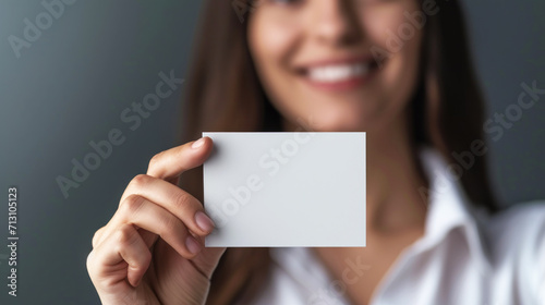 Woman holding blank business card mockup.