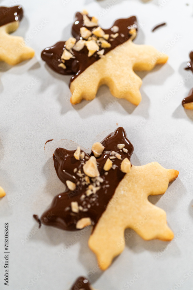 Making Cutout Sugar Cookies, Chocolate-Dipped, Hazelnut-Sprinkled Making Cutout Sugar Cookies, Chocolate-Dipped, Hazelnut-Sprinkled