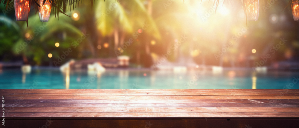Wooden table pool bokeh background, empty wood desk product display mockup with blurry tropical hotel resort abstract poolside summer travel backdrop advertising presentation. Mock up, copy space.