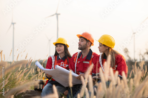 A group of engineers and architects work in floor of base ground of a wind turbine