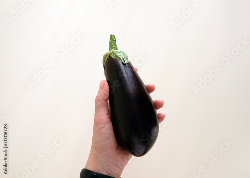 Holding a ripe eggplant in your hand