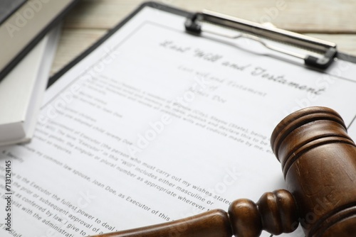 Last Will and Testament, books and gavel on white table, closeup