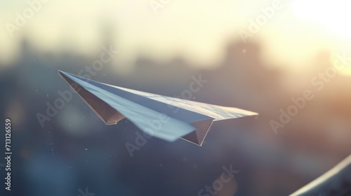 A paper airplane soars through the sky above a bustling city. This image can be used to represent dreams, freedom, adventure, or travel photo