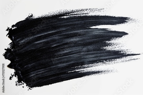 A close-up view of a black brush stroke on a white background. Suitable for graphic design and abstract art projects photo