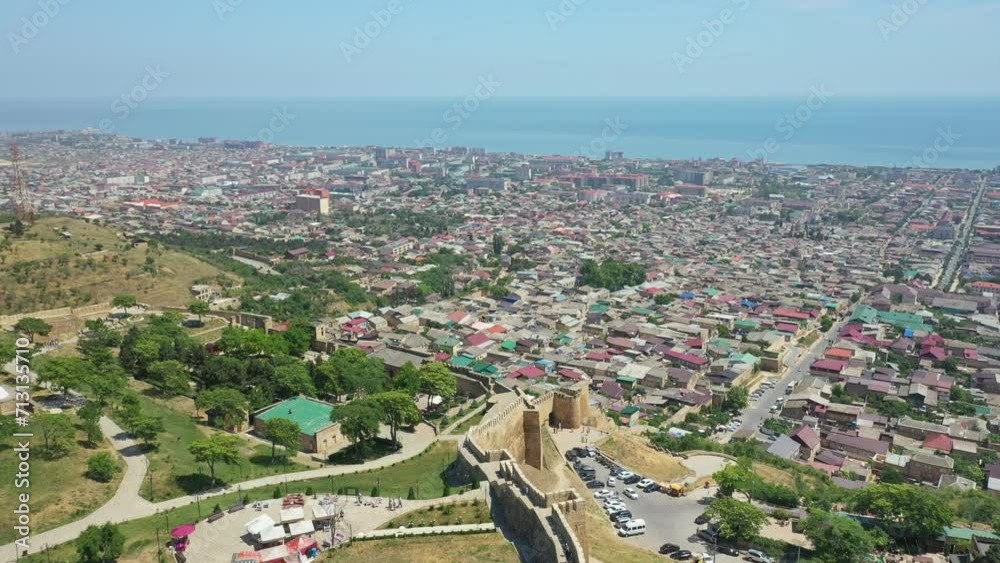 Derbent city in Dagestan. Aerial view of ancient city on the coast of Caspian sea. Travel to Dagestan concept. Revealing shot. Tilt up Derbent city in Dagestan. Aerial view of ancient city on the coast of Caspian sea. Travel to Dagestan concept. Revealing shot. Tilt up