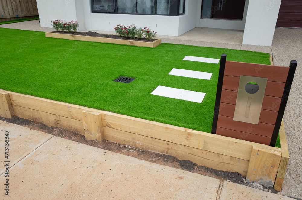 Landscaping project of artificial grass or synthetic turf with a wooden