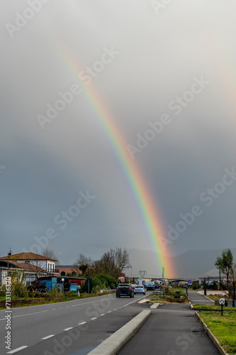 A large rainbow on the road that crosses the hamlet of Lavoria, Crespina Lorenzana, Pisa, Italy photo