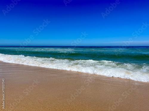 Fototapeta Naklejka Na Ścianę i Meble -  Blue seascape background, clear blue sky and blue sea horizon, sandy coastline