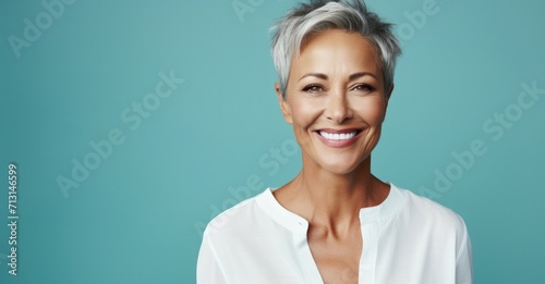 Joyful middle-aged woman radiating beauty with healthy skin and a bright smile photo