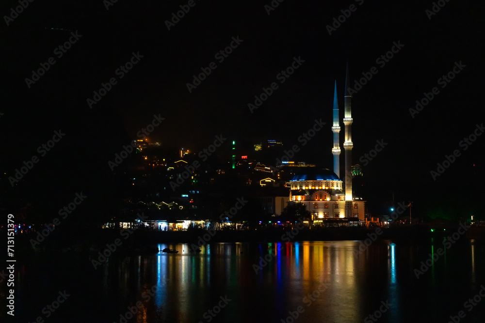 Naklejka premium Illuminated mosque on Uzungol Lake at night, Turkey. Concept of travel, religion