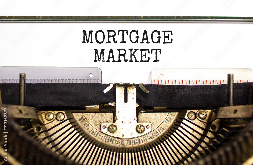 Mortgage market symbol. Concept words Mortgage market typed on beautiful old retro typewriter. Beautiful white paper background. Business mortgage market concept. Copy space.