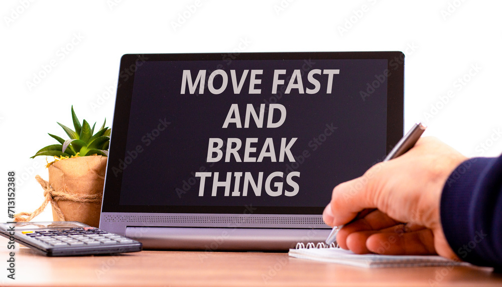 Move fast and break things symbol. Concept words Move fast and break things on beautiful black tablet. Businessman hand. Beautiful white background. Business move fast break things concept. Copy space Move fast and break things symbol. Concept words Move fast and break things on beautiful black tablet. Businessman hand. Beautiful white background. Business move fast break things concept. Copy space