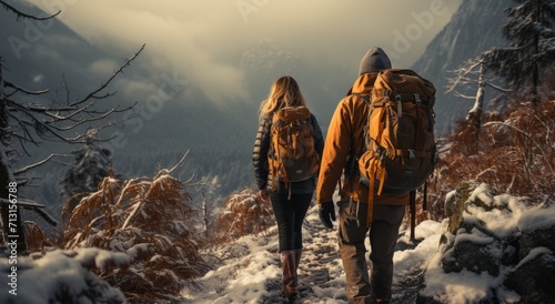 Amidst the winter wonderland, a couple stands atop the frozen mountain, braving the chilling winds in their warm jackets, united in their love for the great outdoors