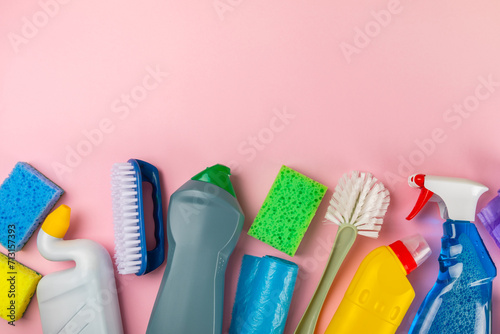 Cleaning service concept.Home cleaning product on a pink background. Bucket with household chemicals. cleaning supplies for home or office space.Early spring regular cleaning. Copy space