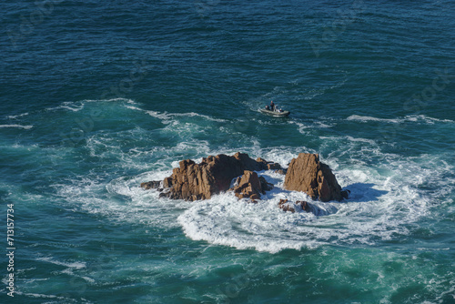 Rock formation surrounded by waves at atlantic ocean coast on westernmost point, Cape Roca, Cabo da Roca, Portugal.